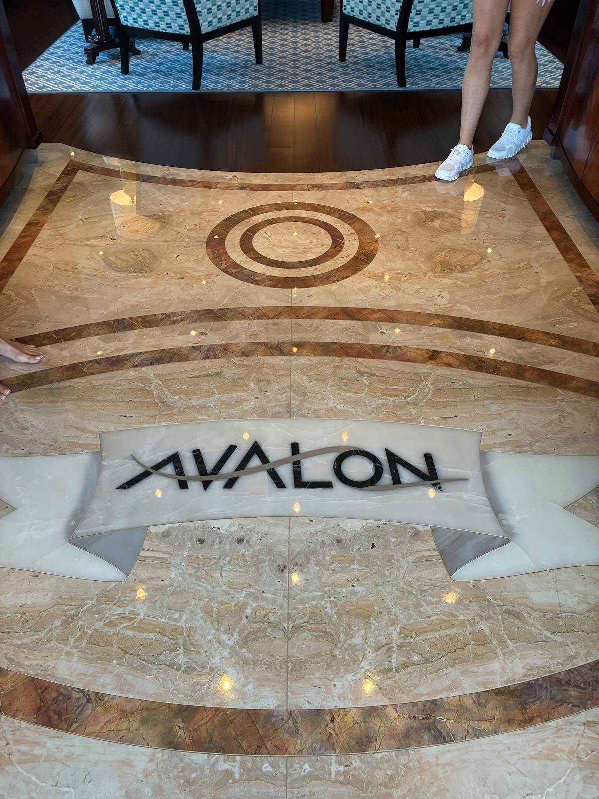 Inlaid marble foyer floor of motor yacht Avalon with the yacht name set into the stone